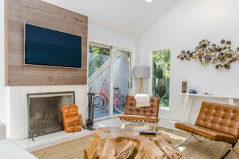 two tufted brown leather chairs in front of brown wood stump center table